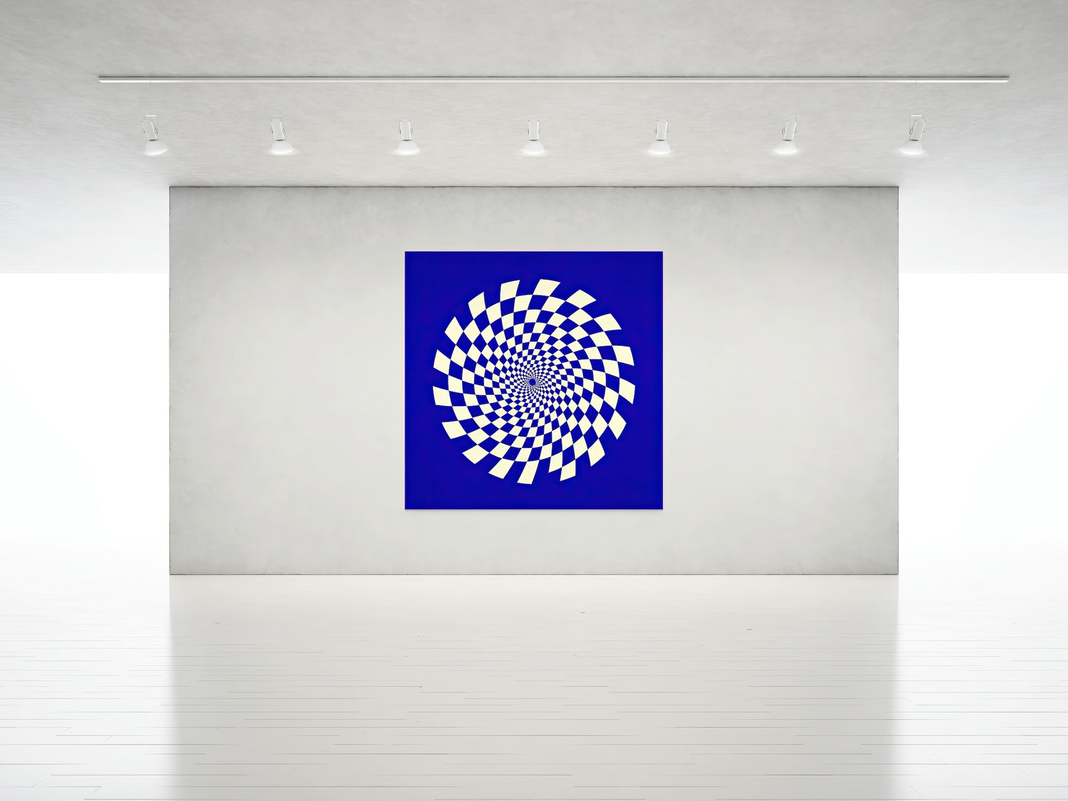 Gravity Bloom artwork in indigo blue and cream, displayed in a modern gallery under spotlights. The piece features a hypnotic spiral of checkerboard shapes radiating outward in lucid symmetry, evoking motion and depth against a rich blue background.